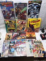 Full view of the comic book lot showing the various titles arranged on a white cloth background.