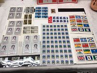 Overview of multiple sheets and blocks of unhinged Canadian stamps including Queen Elizabeth II, flags, flowers, and historical figures.