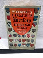 Front cover and dust jacket of the book showing title and colorful heraldic shields.