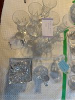 Overhead photo showing all glasses arranged on a table including parfait glasses, sherry glasses, and the square crystal decanter stopper.