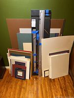 Full view of Logan Simplex mat cutter with multiple mats and boards behind it.