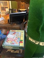 Vintage Barbie Midge puzzle box with 100 pieces on a glass table, alongside a green felt roll mat.