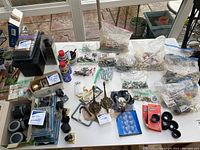 Overview photo showing the collection of hardware items spread over a large table.
