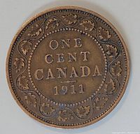 Reverse side of the 1911 Canadian large one cent coin showing denomination and date with maple leaf wreath.