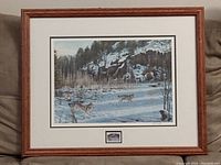 Full framed print displaying winter scene with wolves and surrounding forest and cliffs.