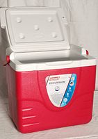 Photo of a red and white plastic Coleman Excursion cooler with lid open, showing interior.