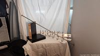 Photo shows all items: two Ikea floating shelves standing upright, one wooden strip with four metal coat hooks, and one silver adjustable tension curtain rod laid horizontally.