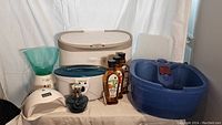 Photo showing entire collection of home spa accessories including UV nail dryer, facial mister, paraffin wax dipper with block, hot stone/towel warmer, foot spa basin, and Lampe Berger scent diffuser with scents.