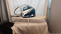 Rowenta steam generator iron and small ironing board together