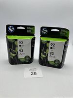 Two sealed HP ink cartridge packages, each containing black 92 and color 93 cartridges, front view.