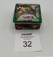 Top and side view of the trinket box showing colorful bird and flower design.