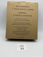 Box showing label with quantity, brand, and origin information for 11 piece nativity scene.