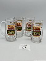 Four clear glass mugs arranged together showing Ontario Racetrack Slots logo and Slotoberfest text.