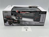 Front angled view of the boxed Phantom Red Lightning R/C car showing the front and side of the black and red racing car with visible wheels and clear window packaging.