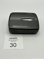 Top view of the Rhapsody cassette player showing branding and feature texts, with visible surface scratches.