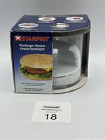 Front view of Starfrit Hamburger Stacker in original box showing product and branding.