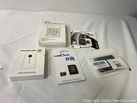 Photo showing the full lot with all items: Portable SSD enclosure, Core Micro memory card, Kingston USB drive, numeric keypad, and small electronic parts in bags.
