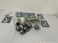 Overview of the lot showing fishing weights, multiple spools of fishing line, and the container of frog lures.