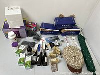 Photo of various boxed and bottled skincare and personal care products, including herbal tinctures, serums, and creams.