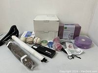 Overall view of sports and health items including boxes, baseballs, weights, resistance bands, grip tape, and straps.