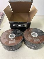 Two new Linconson 5-inch reinforced metal cut-off wheels sealed in plastic packaging beside the open box with Linconson branding.