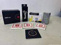 Full lot showing Douk Audio speaker box, Musiclily box, Ezcap music digitizer box, Donner mini pedal box, and three packages of Ernie Ball guitar strings (two size 46, one size 32).