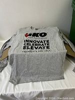 Single gray long sleeve T-shirt laid flat showing front logo and text