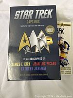 Star Trek Captains DVD set in black box with silver Star Trek insignia and character names.
