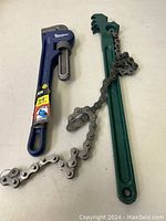 Both tools side-by-side - Ruikarhop chain wrench with metal chain and Tool Tech pipe wrench with an adjustable jaw, showing their full length and chain detail.
