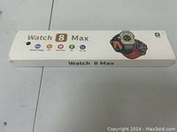 Box of Watch 8 Max showing branding and feature icons (wireless charging, NFC, heart rate, sport, calorie).