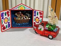 Full view of both items: Peruvian Noah's Ark shadow box with painted doors and glass snowman truck ornament