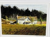 Front view of the watercolor farmhouse scene print in black frame and white matting under glass