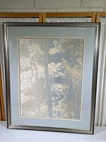 Photo of the entire framed piece showing the artwork, triple matting and silver-toned frame.