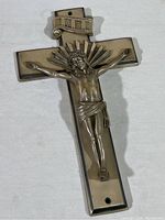 Full view of the vintage metal crucifix showing the figure of Jesus and cross shape.