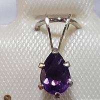 Front view of the pear-shaped amethyst pendant set in 14K yellow gold, showing gemstone and prong settings.