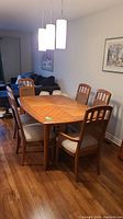 Full dining set showing table, six chairs and leaves