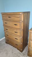 Full view of vintage tall boy dresser showing five drawers and handles