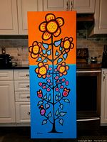 Front view of full canvas displayed on kitchen floor against cabinets