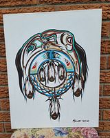 Full frontal view of Native-inspired original acrylic painting on white canvas depicting stylized feathers and circular patterns.