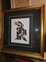 Overall photo of framed fine art print 'Seagull' by Chief Henry Speck showing gold frame and black matte, print centered within.