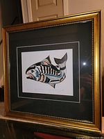Full view of framed 'Tyee Salmon' art print with gold frame and black mat showing the fish artwork in traditional West Coast indigenous style.