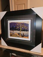 Framed fine art print showing overall front view, corners protected with white corner protectors.