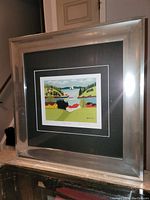 Frontal view of artwork in silver metallic frame showing entire piece and matting.