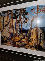 Close-up of the fine art print showing the detailed brushstroke style and handwritten print title and artist name "Pine Cleft Rocks by Tom Thomson".