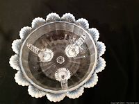 Top-down photo showing the interior and scalloped edges of the opalescent candy bowl against a dark background.