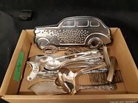 Box with vintage silver plated flatware and car-shaped item