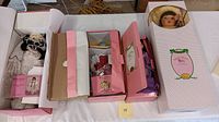 Four heirloom style collector dolls in original boxes, showing variety of packaging and styles