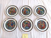 Six 8-inch Limoges collector plates with colorful stained glass style Christmas religious scenes and gold decorative borders.