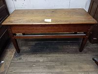 Top surface view showing scratches and wood grain of the console table