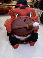Front view showing the bulldog's angry eyes, hat, cigar, and outfit.